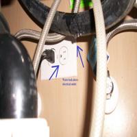 Water leak under kitchen sink affecting outlet found during home inspection in Spring, TX 
